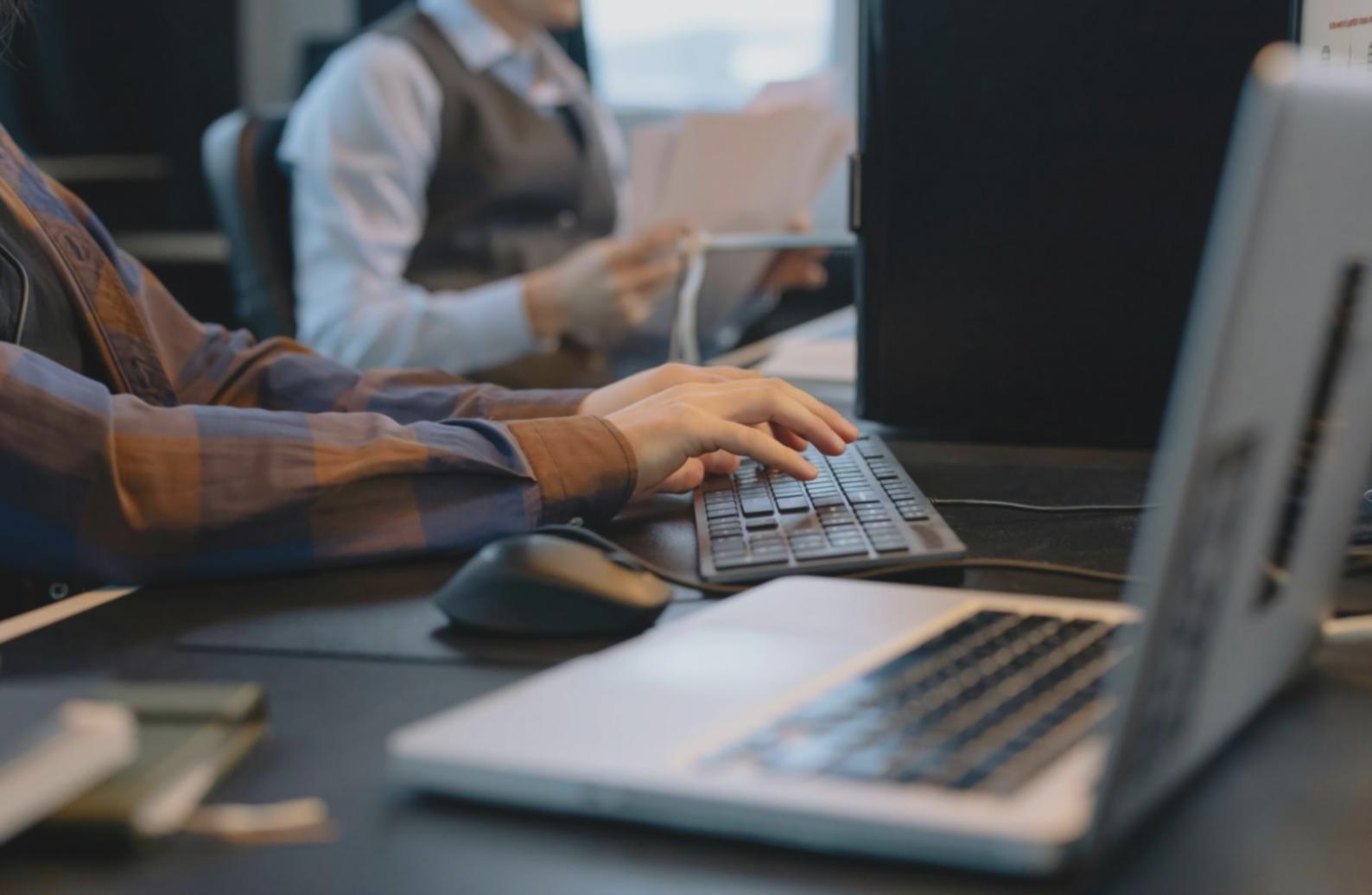 Espace de travail avec plusieurs écrans montrant des projets de modélisation 3D en cours de développement
